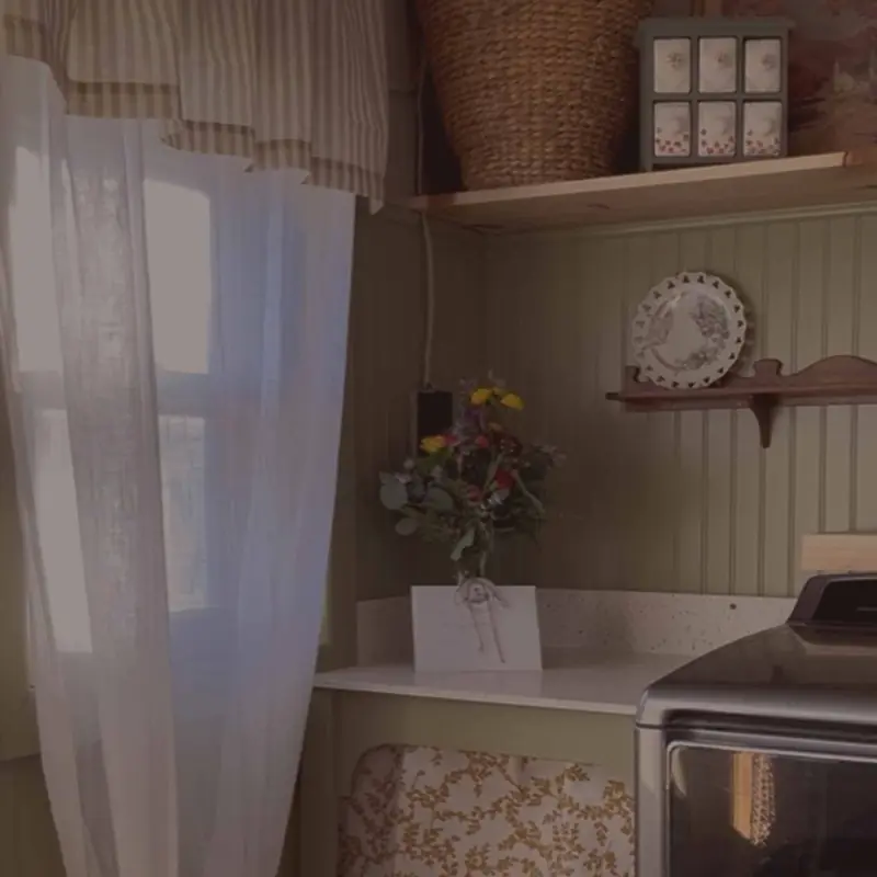Laundry nook with floral details, beadboard and woven baskets
