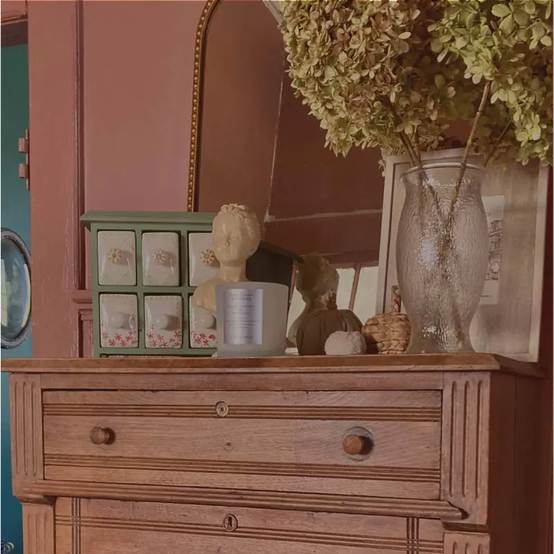 Styled dresser with a vintage mirror and dried hydrangeas